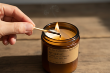 Load image into Gallery viewer, Hand lighting Patchouli Sweetgrass candle with match
