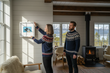 Load image into Gallery viewer, Norwegian person hanging small 10x10 Puffin print in traditional hytte